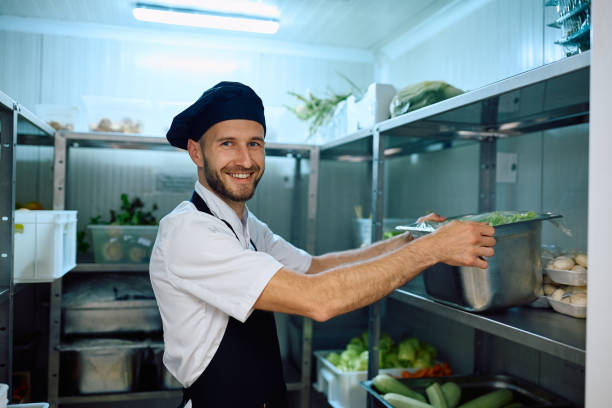 istock Happy cook taking fresh vegetables from the pantry and looking at camera. 2158371321