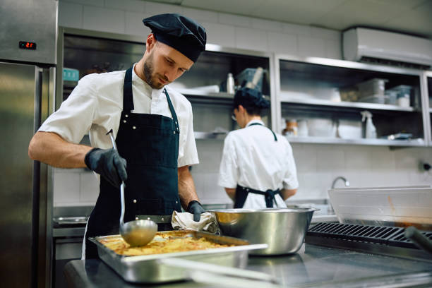 istock Restaurant chef preparing food in the kitchen. 2158371510