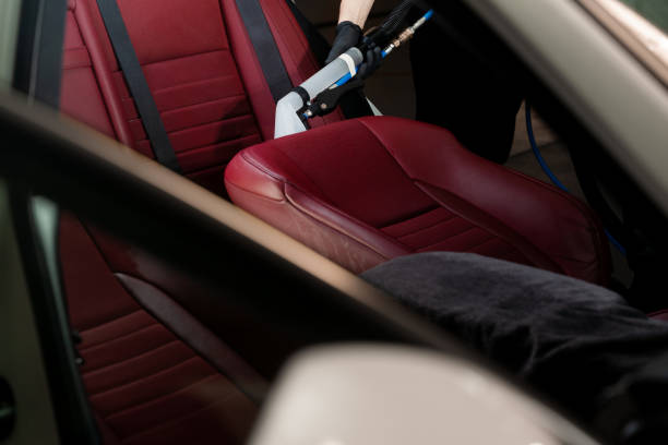 istock Detailing auto seat using vacuum extractor. Removing dirt from car seat with the help of special hoover nozzle. 2158371988