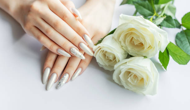 istock Female Hands on a white background with beautiful pearl manicure 2158372019