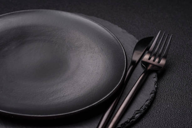 istock Empty round slate plate for template on the black background 2158372694