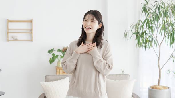 A woman who feels happy with her hands on her chest