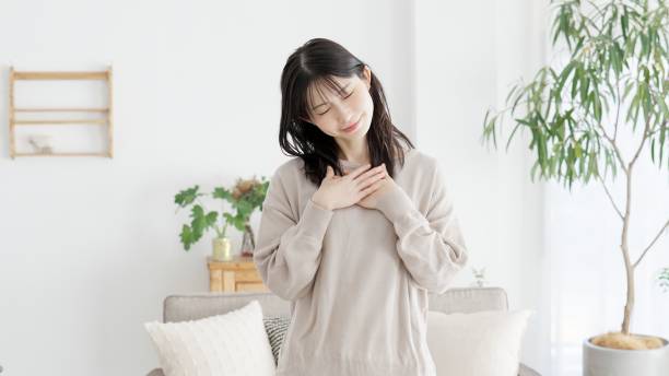 istock A woman who feels happy with her hands on her chest 2158372769