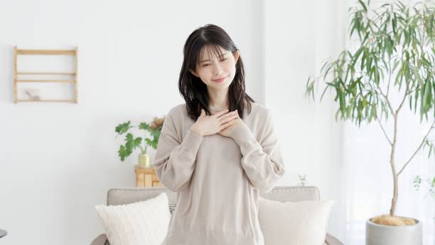 istock A woman who feels happy with her hands on her chest 2158372778