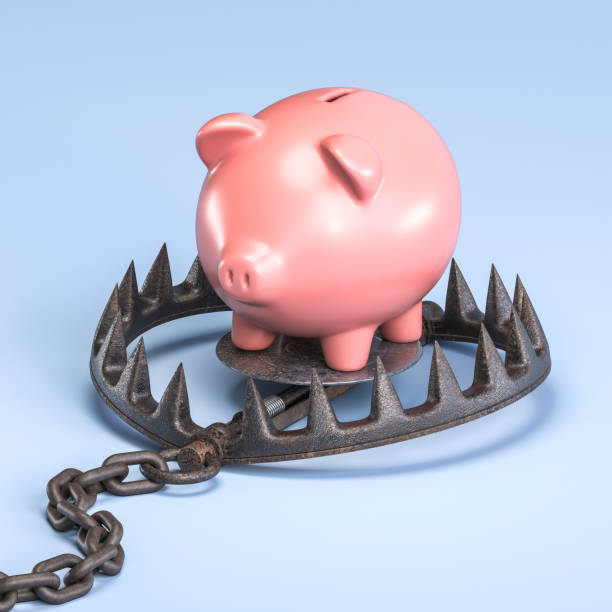 istock Piggy bank balancing on a bear trap 2158373356