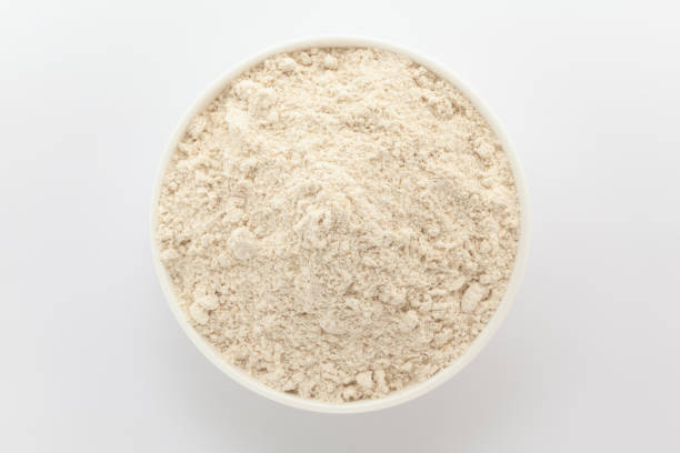 istock Organic Wheat flour (Triticum) in a white ceramic bowl. Isolated on a white background. Top View 2158374218