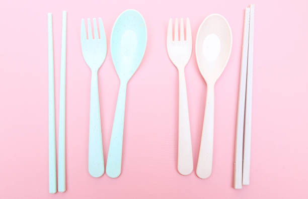 Utensils set colorful fork, chopstick and spoon isolated on pink background