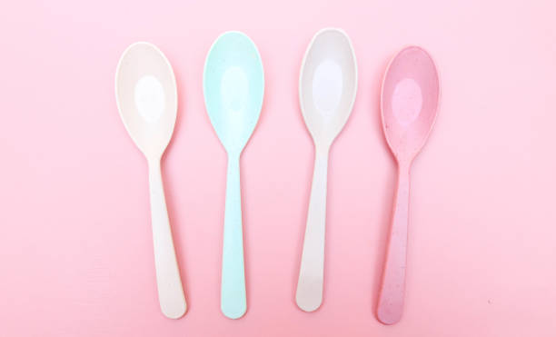 istock Different stylish colorful plastic spoons isolated on pink background. Colorful spoon cutlery set 2158374385