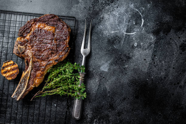 istock BBQ Grilled Tomahawk or rib eye with bone beef steak. Black background. Top view. Copy space 2158374713