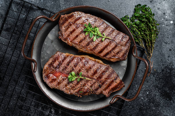 istock Grilled Top Blade or flat iron beef meat steaks. Black background. Top View 2158374847