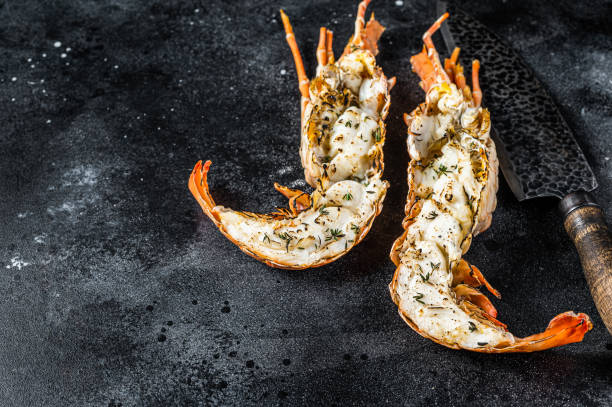 istock BBQ Grilled Spiny lobster sliced on a cutting board Black background. Top view. Copy space 2158376403