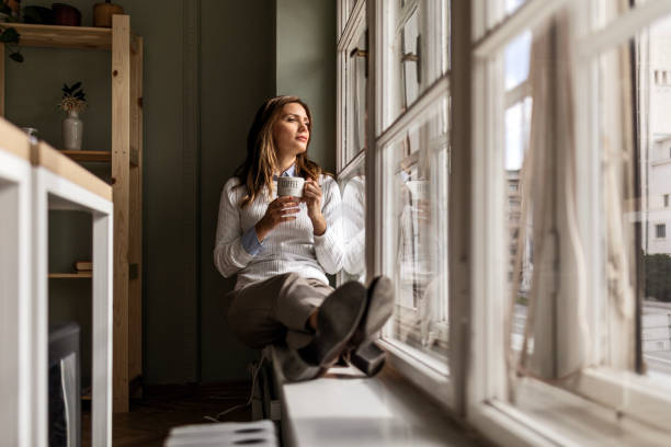 istock Businesswoman Enjoying Coffee Break by the Window 2158376813