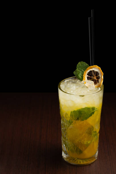 istock mojito tropical cocktail on wooden table with dark background 2158377161