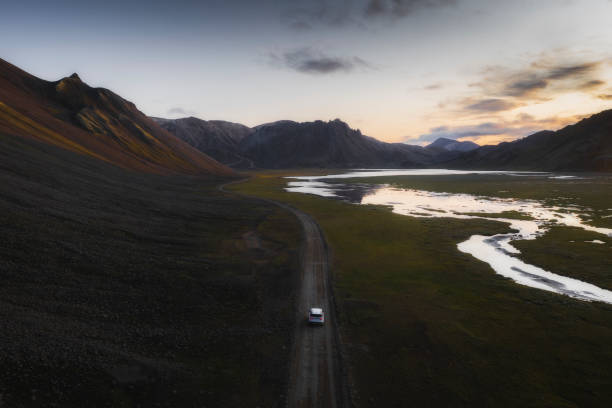 istock 2019, Iceland, White Landrover driving on a dusty sand road 2158380202