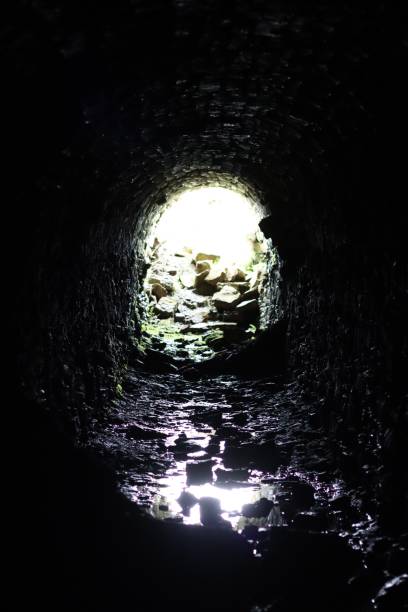 istock Light at the end of a long stone tunnel 2158381250