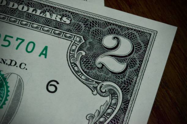 istock Dollars bills close up views two dollars 2158381410