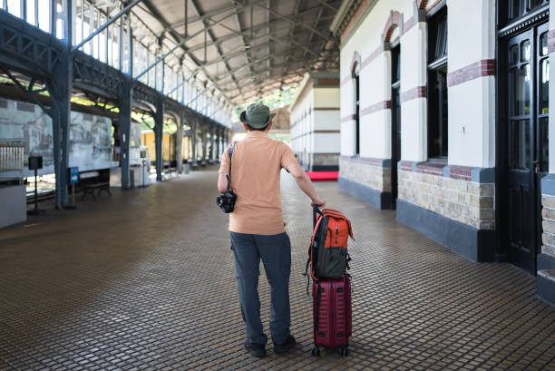 asian man traveler with suitcase in the railway