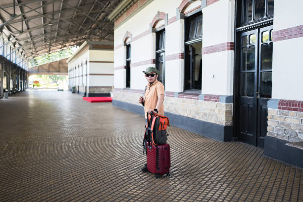 asian man traveler with suitcase in the railway