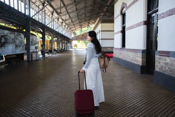 istock female traveler waiting the train 2158381657