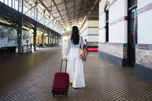 Young asian woman traveler with suitcase in the railway