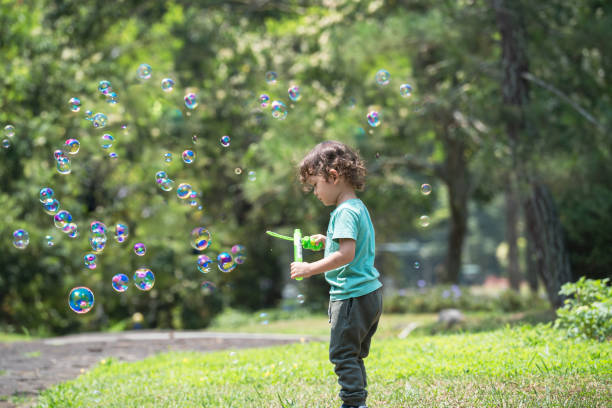 istock Preschoolers boy soap bubble play time 2158382027