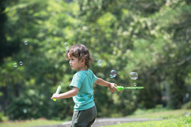 istock Preschoolers boy soap bubble play time 2158382056