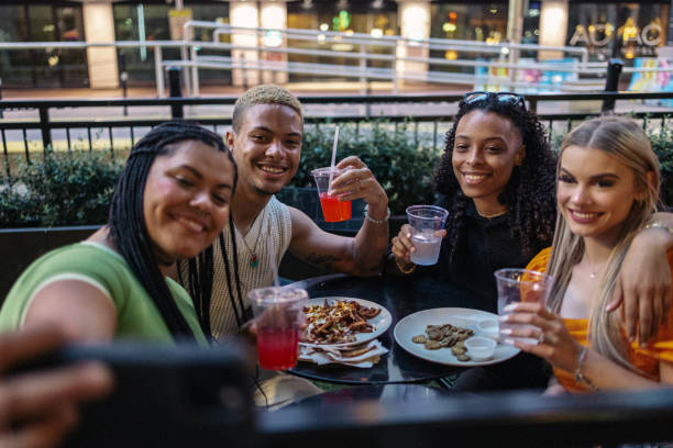 istock Diverse group of friends making a self portrait during the dinner. 2158383067