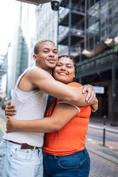istock Happy friends hugging on urban street background 2158383113