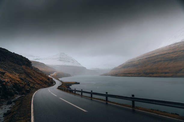 istock Scenery country road by the lake background 2158385658