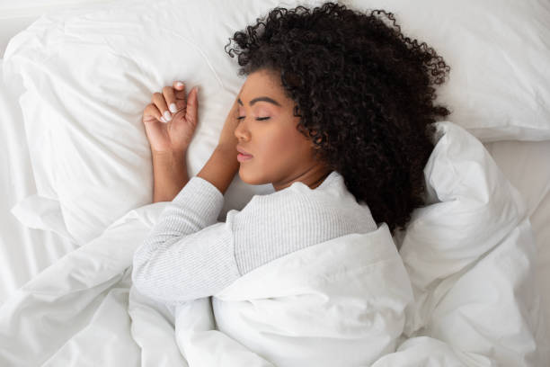 istock Woman Laying in Bed With Eyes Closed 2158385868