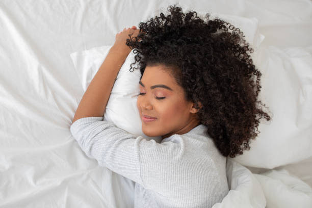 istock Young Hispanic Woman Laying in Bed With Pillow 2158385923