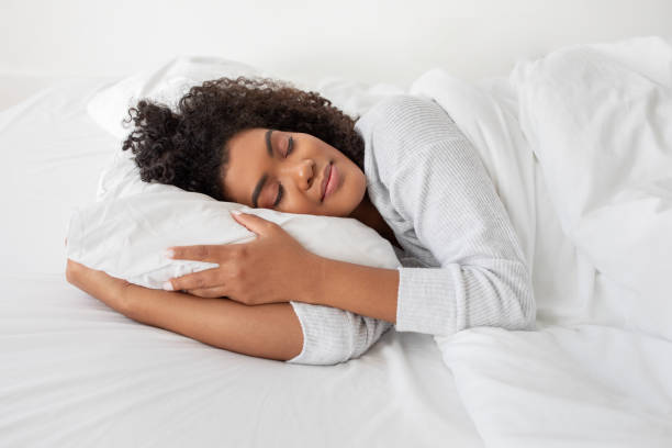 istock Woman Laying in Bed With Pillow, Side View 2158385928