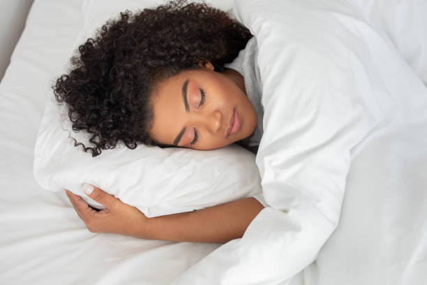 istock Woman Laying in Bed With Eyes Closed, Sleeping 2158385960