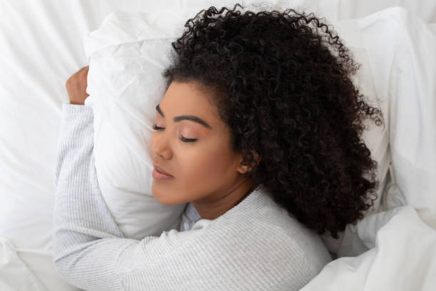 istock Woman Laying in Bed With Head on Pillow 2158385990