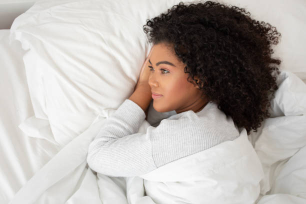 istock Woman Laying in Bed With White Blanket 2158385995
