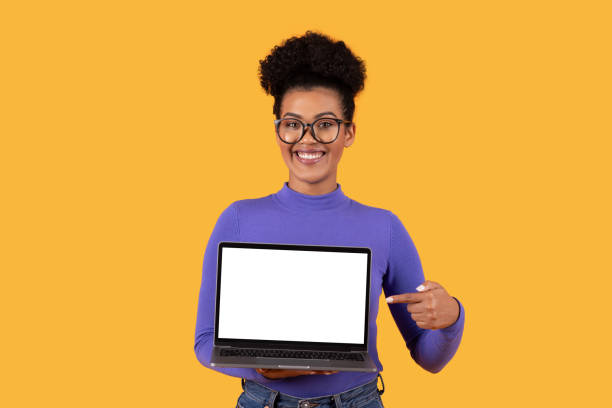 istock Woman Holding Laptop With Blank Screen, Yellow Background 2158386305