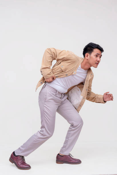 Full length portrait of happy businessman on grey background. Space for text