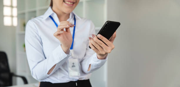 istock Professional Female Accountant Working in Modern Office Environment with Smartphone and ID Badge 2158392347