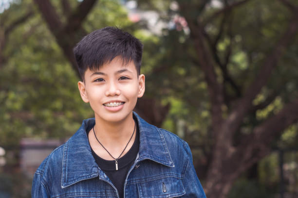 istock A cute young man in happy thoughts. Delighted about the compliments about him. Standing outside the park. 2158395913