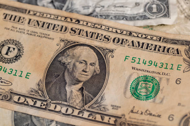 Old yellowed one dollar close-up , American old cash paper dollars close-up