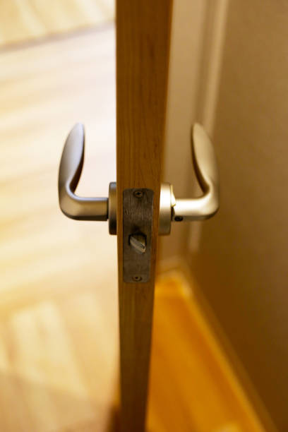 istock Wooden door open, metallic handle 2158397593
