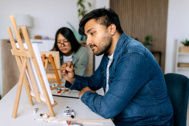 istock Young casually clothed couple crating art at home 2158398543