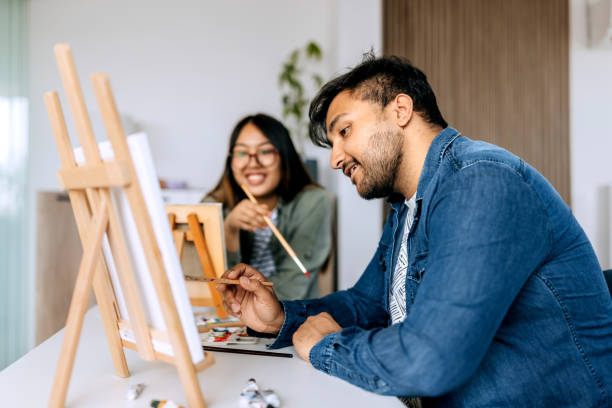 istock Young casually clothed couple crating art at home 2158398583