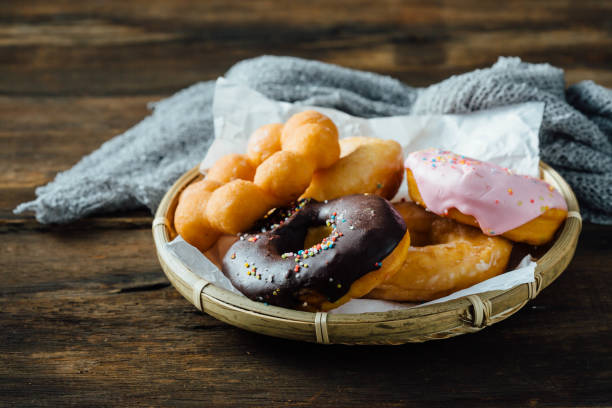 istock Various types of donuts on wooden background 2158398989