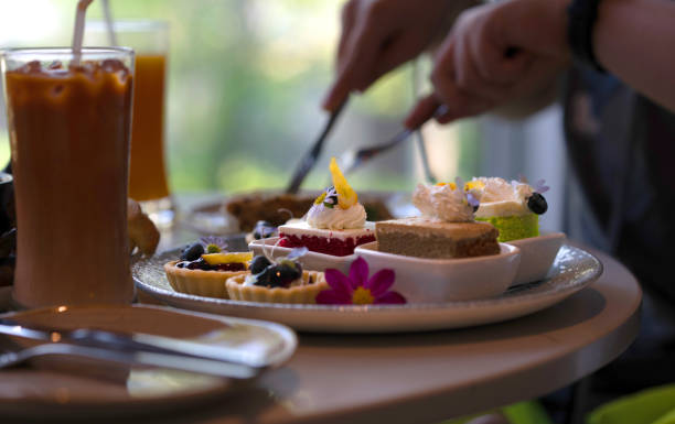 istock cake and tart dessert on table on  blur person eating background 2158403231