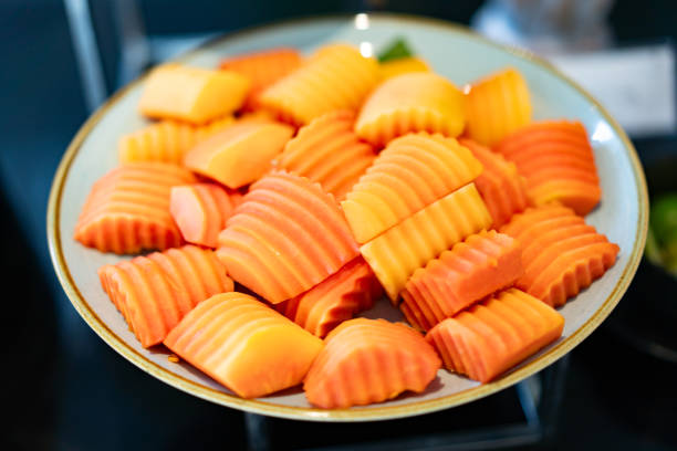 riped sliced papaya in big plate in hotel buffet course