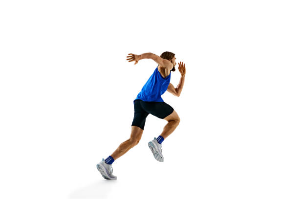 istock Dynamic image of man in a run, runner in motion, training isolated on white studio background. Speed and endurance. 2158403564