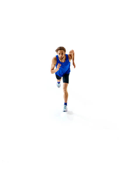 istock Dynamic image of athletic young man in blue uniform, competitive runner in motion, training isolated on white studio background 2158403565