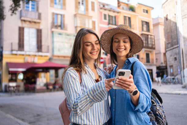 istock Two young women using a phone while exploring the streets of Palma de Mallorca 2158403884