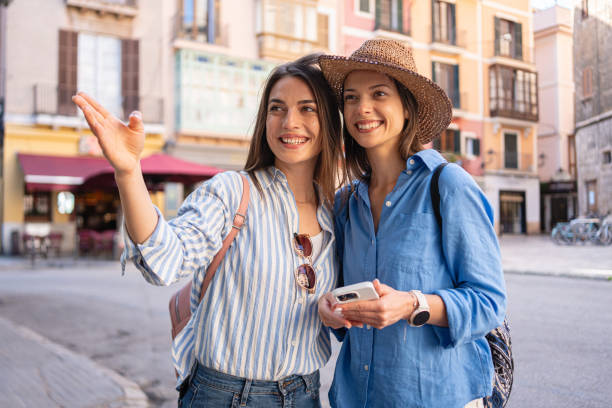 istock Two young women using a phone while exploring the streets of Palma de Mallorca 2158404079